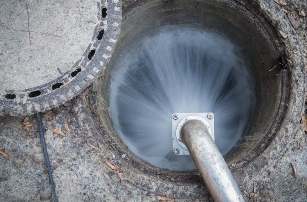 A Professional Jetting team member conducting hydro jetting in Cheatham County, TN, demonstrating the effectiveness of high-pressure water cleaning in maintaining clear pipes.